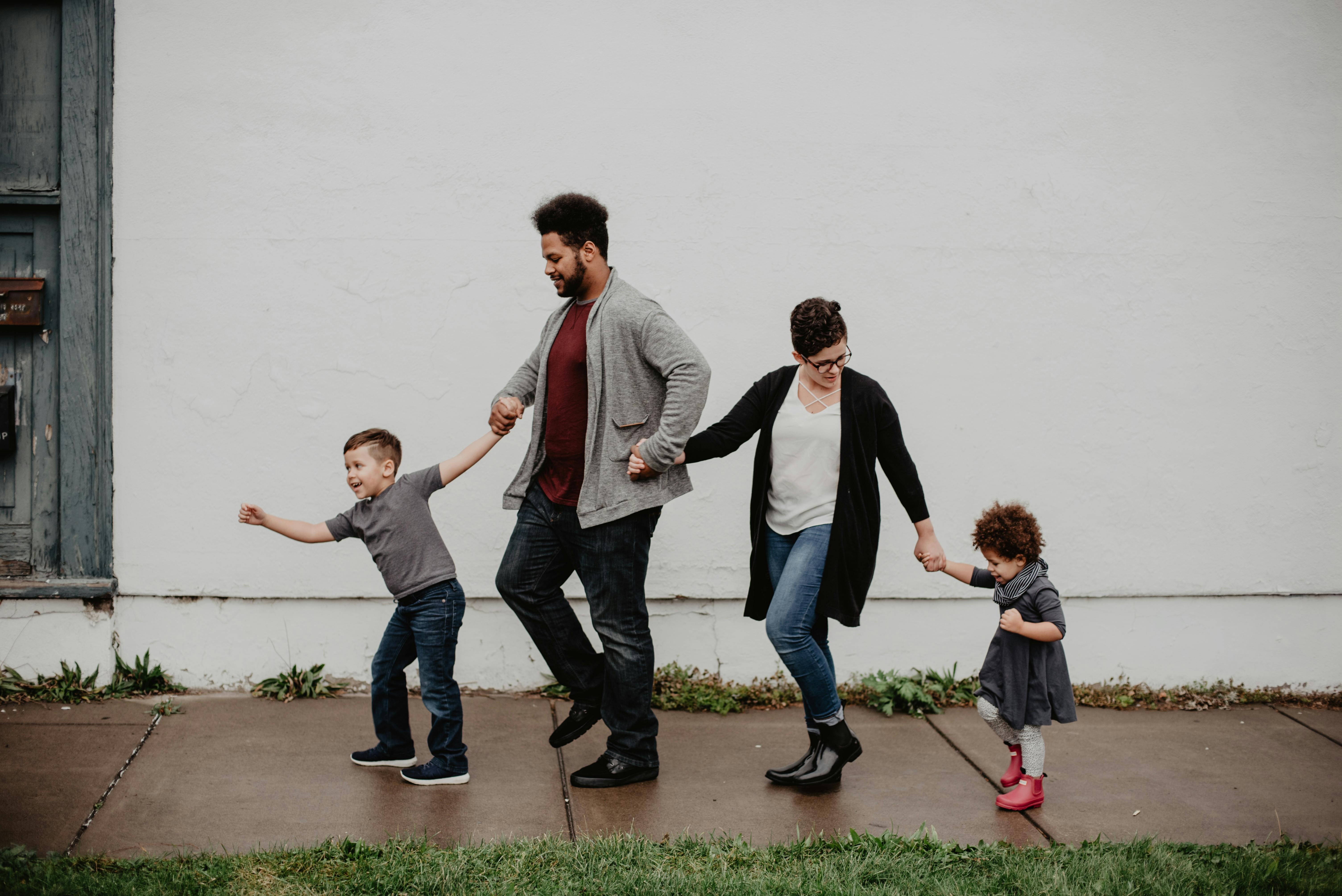 Family walking together outdoors, representing the unity and financial security that life insurance provides for first-time homebuyers