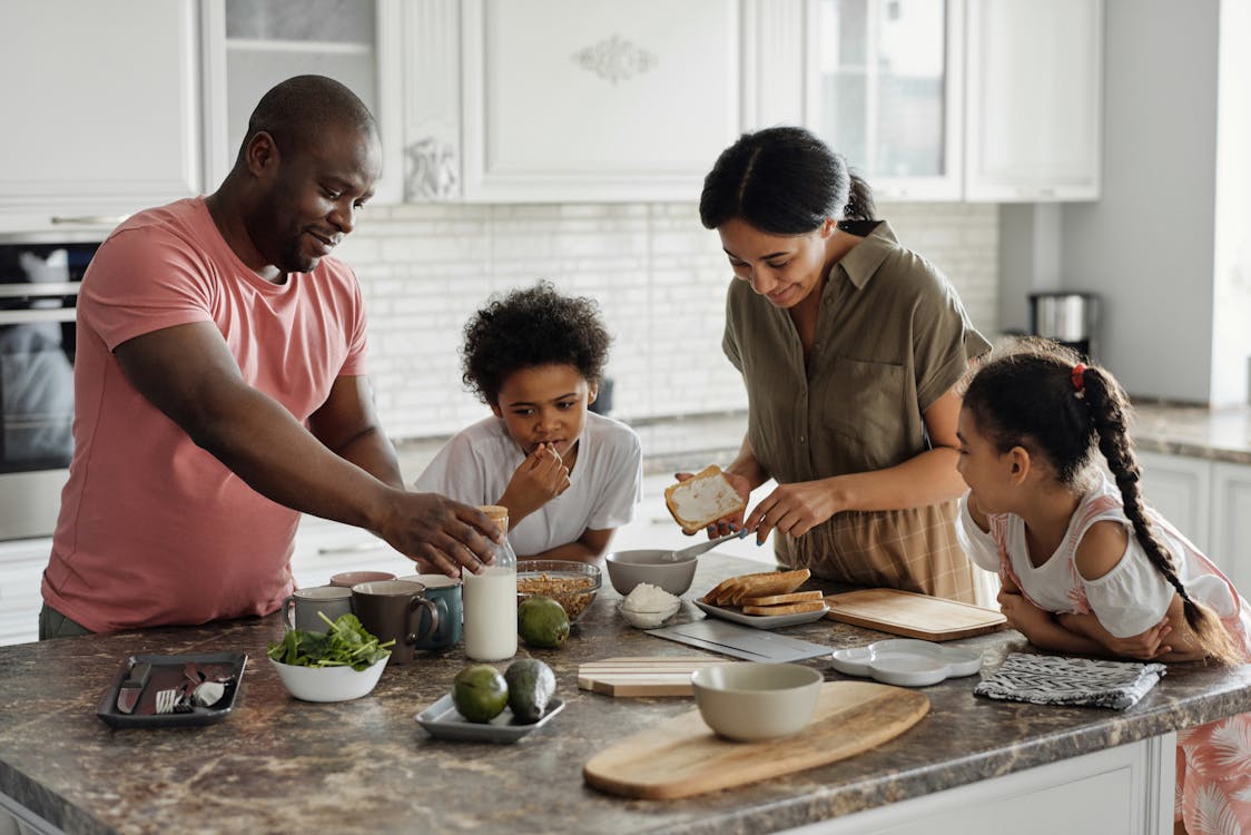 Family preparing a meal together in their kitchen, illustrating the everyday moments that motivate parents to secure their children's college future