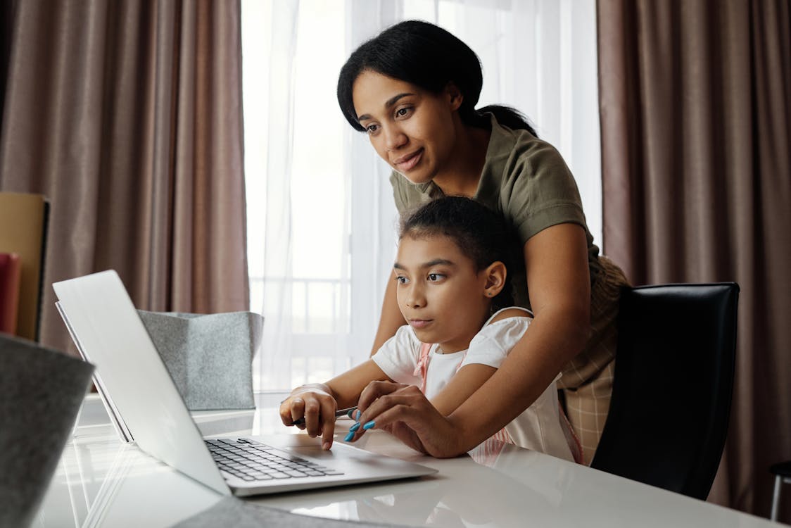 Mother and daughter researching life insurance options together on a laptop, showing how an independent agent can simplify the process