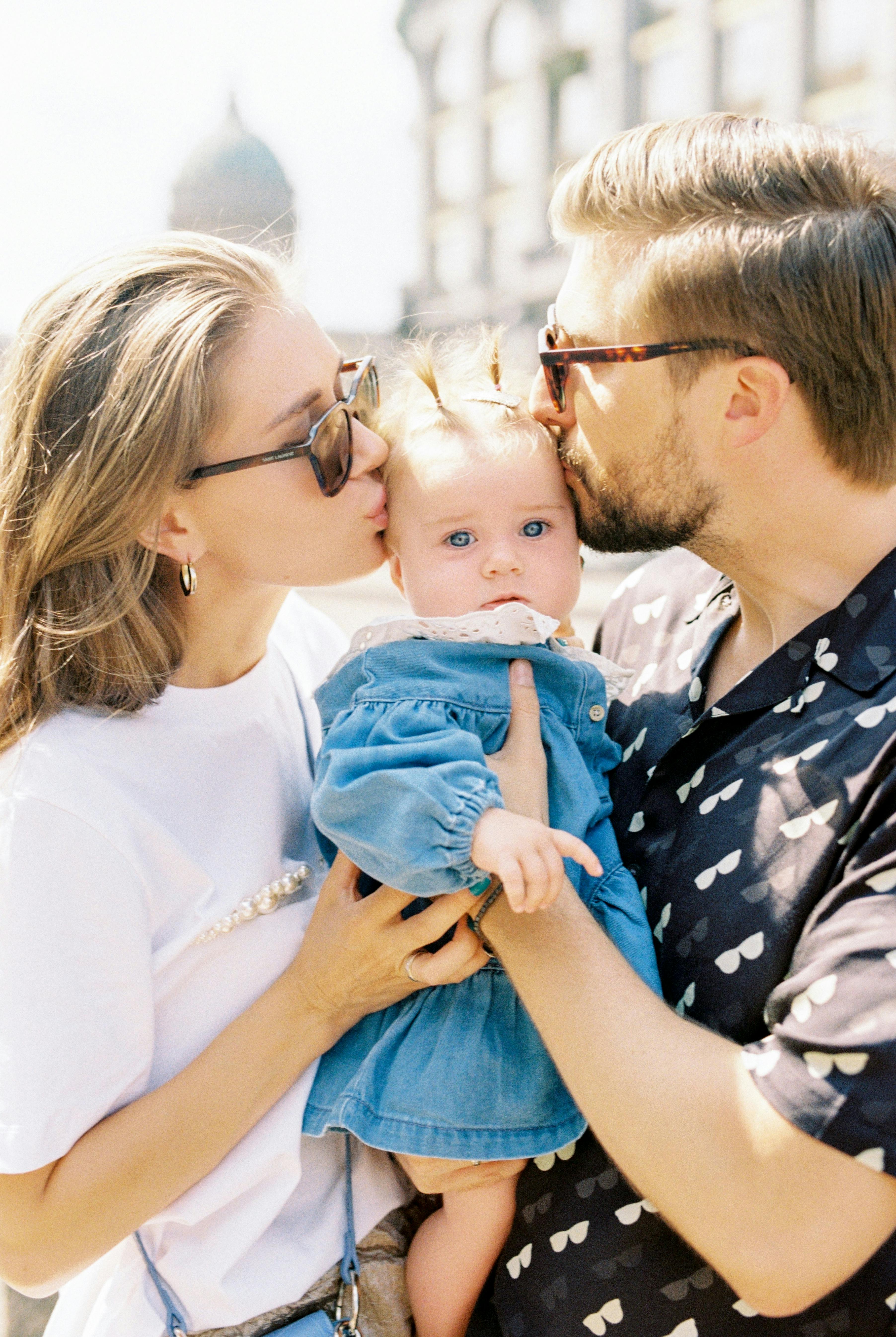 Young couple with infant enjoying outdoor time together, symbolizing family security and financial protection through life insurance